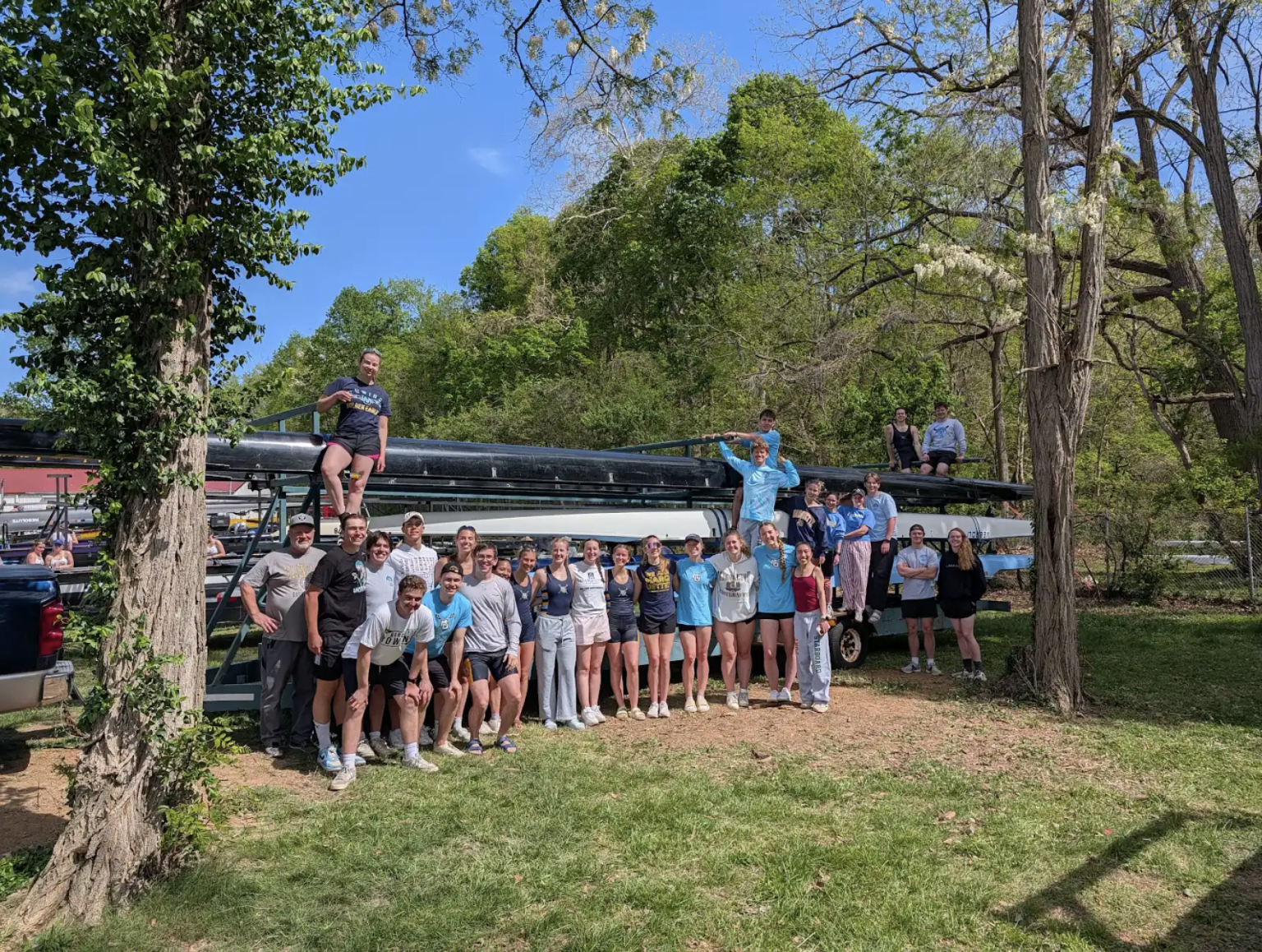 The full Marquette Crew team gathered around the boat trailer after a spring race.