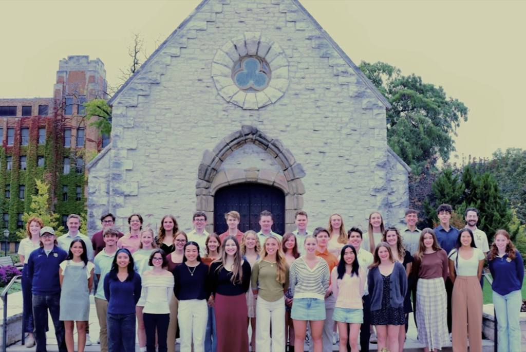 The team gathered outside St. Joan of Arc Chapel on campus.