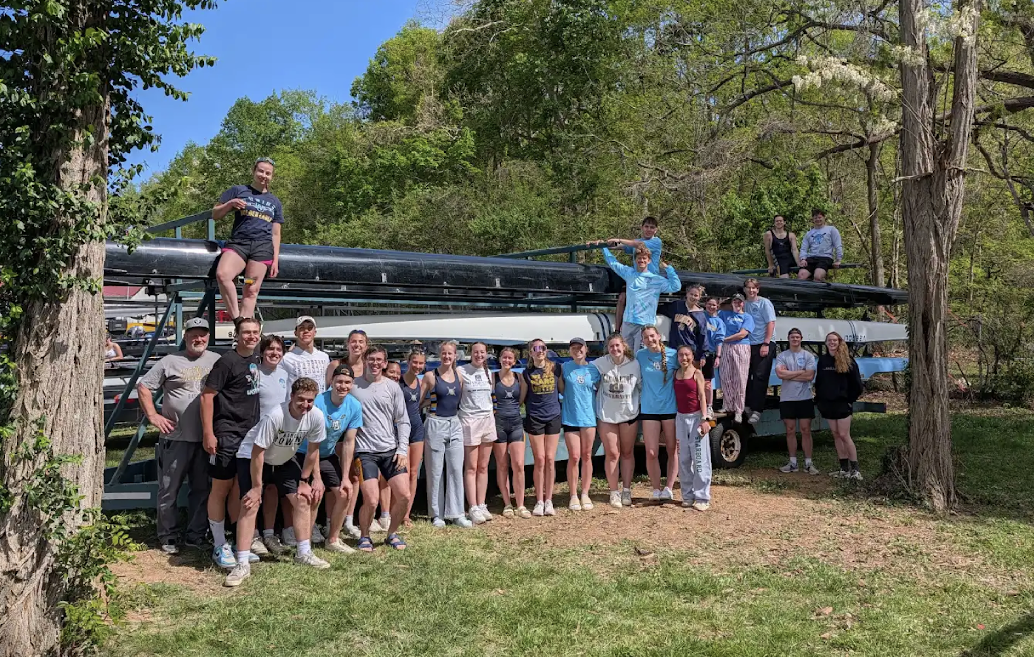 The full Marquette Crew team gathered around the boat trailer after a spring race.